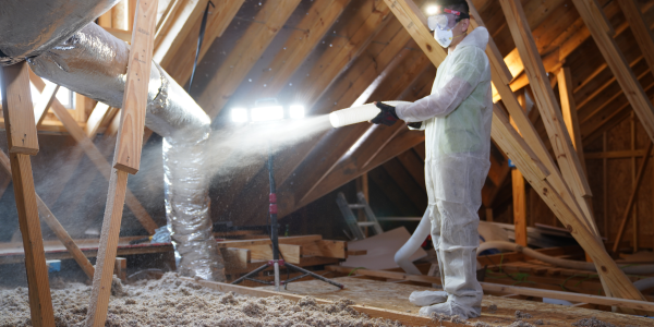 service man providing indoor air quality service in attic
